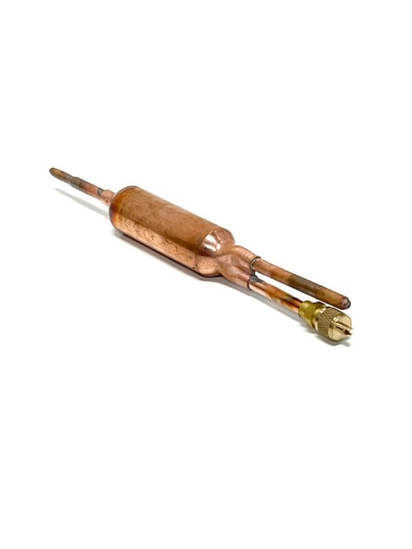 A copper wire stripper is sitting on the ground.