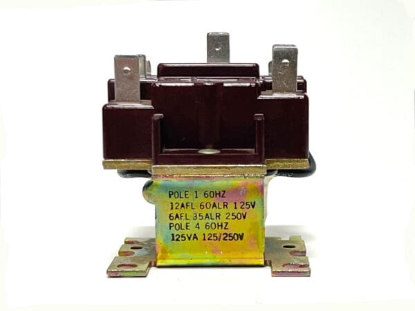 A brown relay with yellow lettering and some brown wires