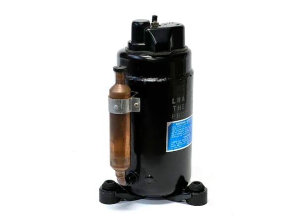 A black compressor with copper tube and air pump.
