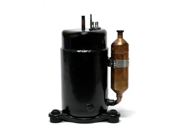 A black and brown compressor is sitting on the floor.