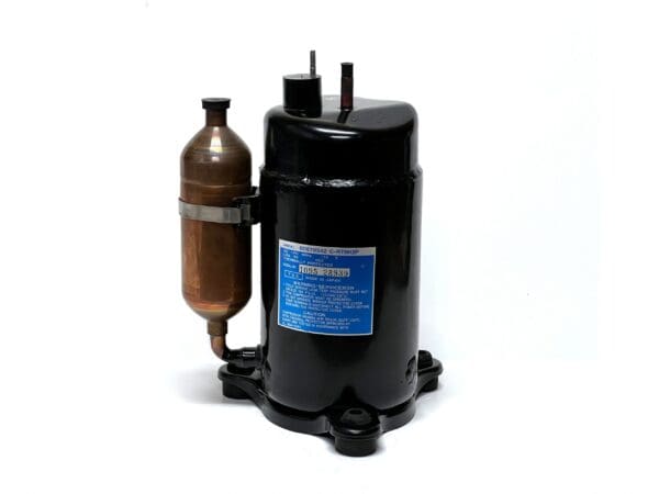 A compressor is sitting on the floor with its air tank attached.