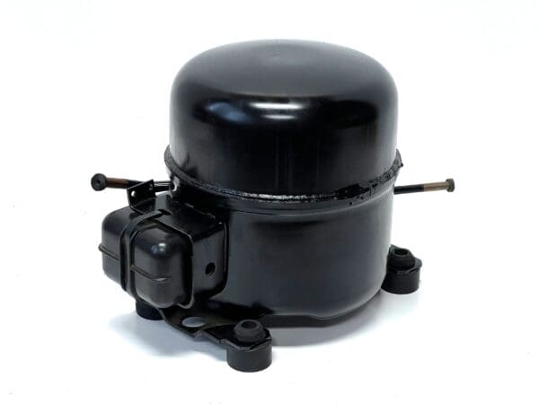 A black air compressor on top of a white surface.