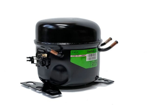 A black compressor with green label on it.