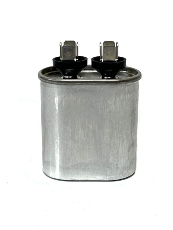 A capacitor is shown with two black caps.