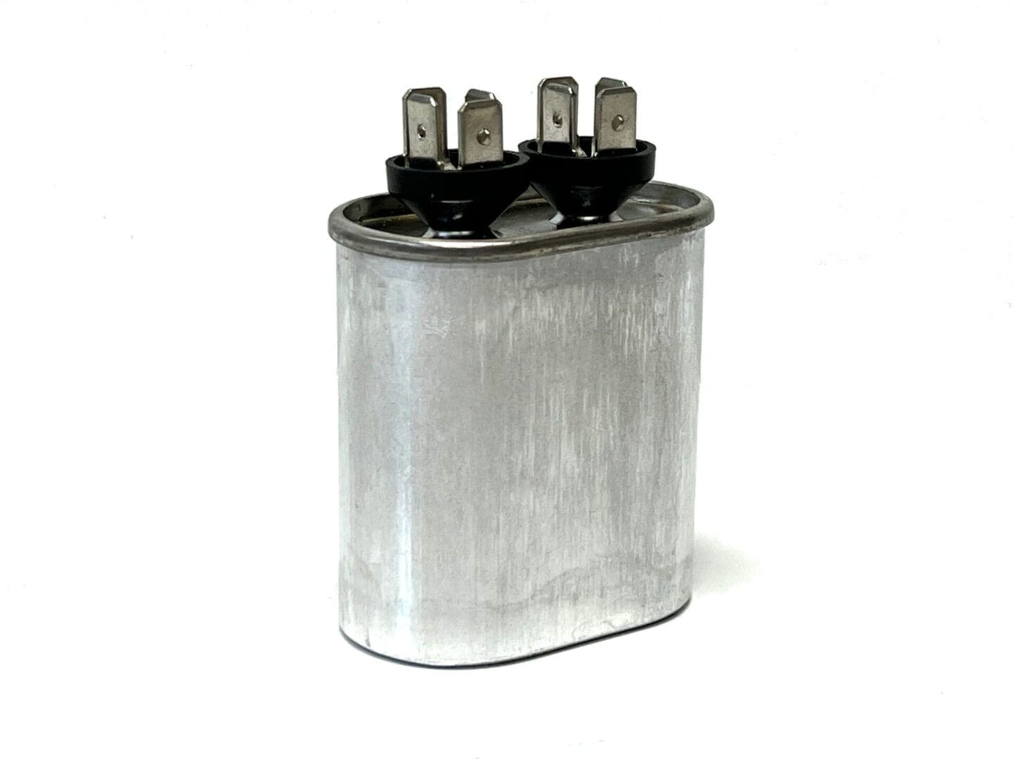 A close up of an electrical capacitor on a white background
