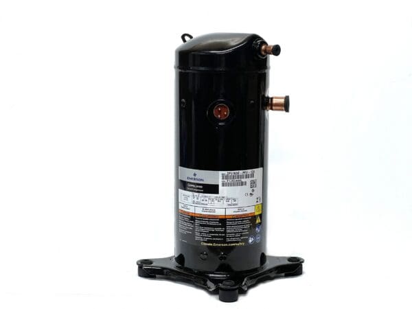 A black compressor sitting on top of a white table.