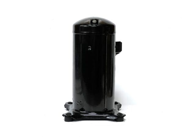 A black compressor is sitting on top of the floor.