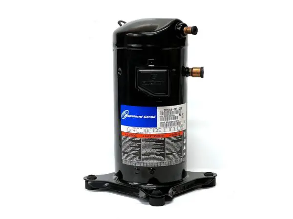 A compressor is sitting on the ground.
