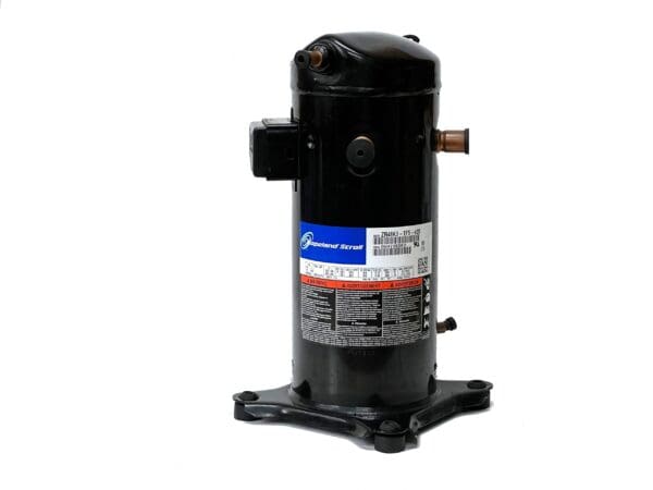 A compressor is sitting on the ground.