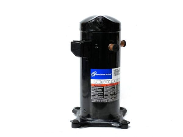 A compressor is sitting on the ground.