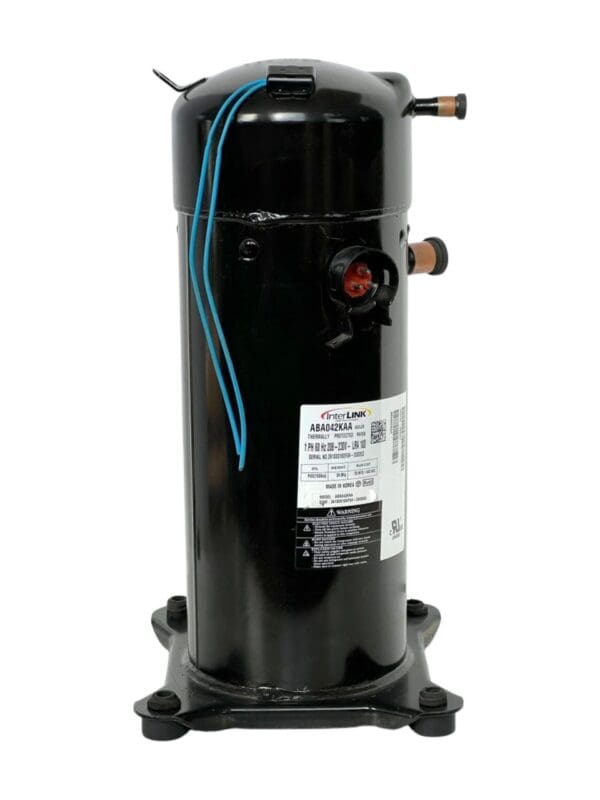 A black compressor is sitting on top of the floor.