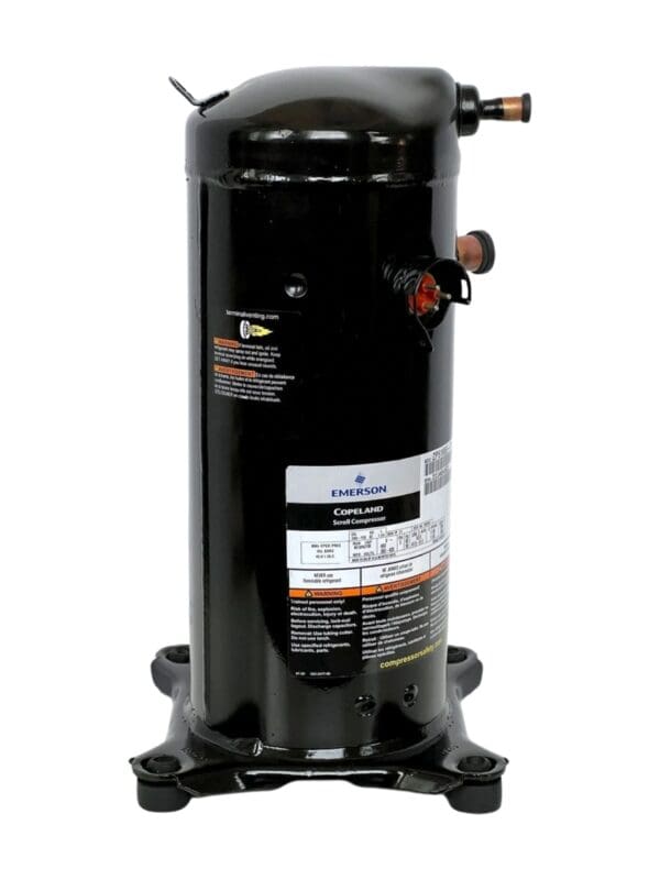 A black compressor is sitting on top of the floor.