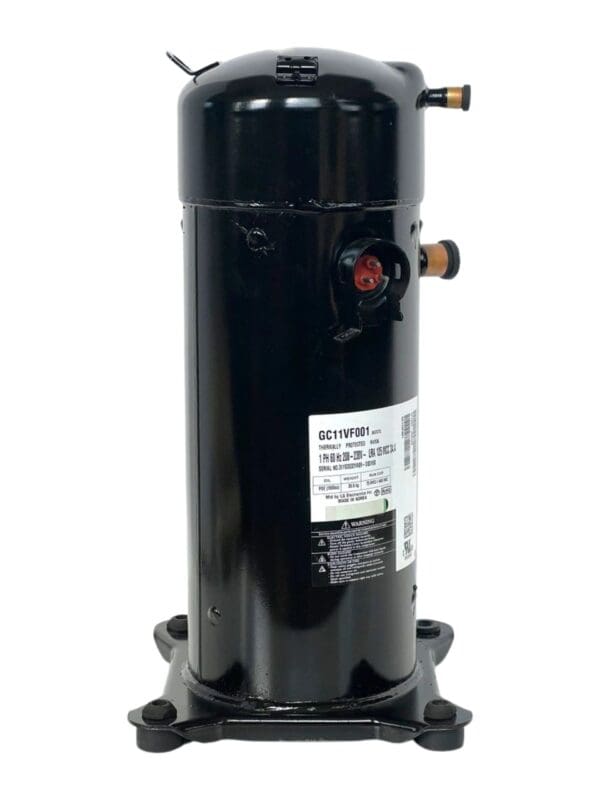 A black compressor is sitting on top of the floor.