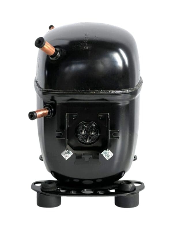 A black and silver air compressor on top of a white wall.