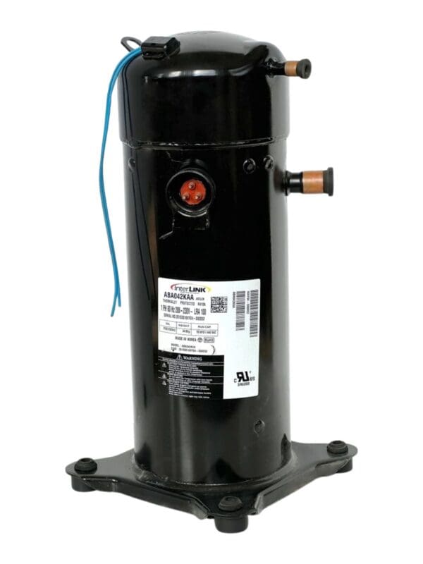 A compressor is sitting on the ground.