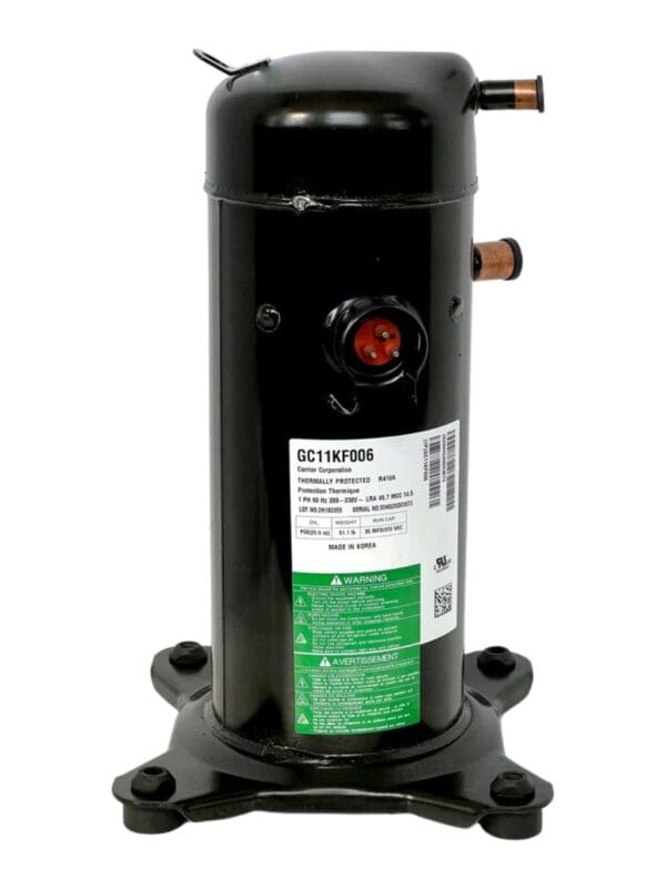 A compressor is sitting on top of the ground.