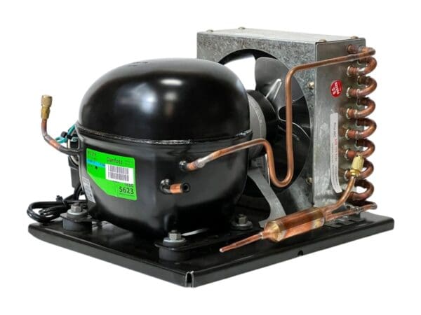 A black compressor with copper pipes and valves.