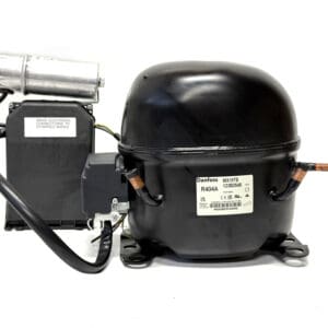 Refrigeration compressor with attached electrical components.