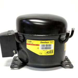 Refrigeration compressor with yellow label.