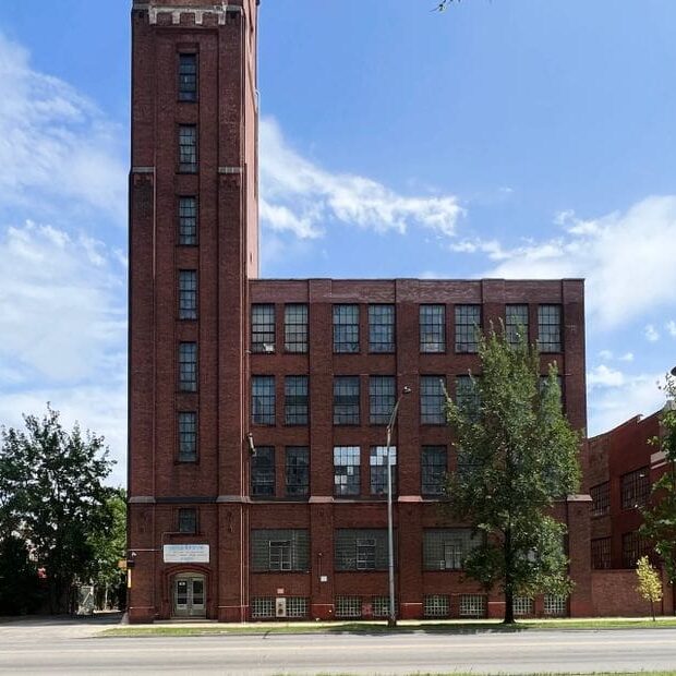 A large brick building with a tall tower.